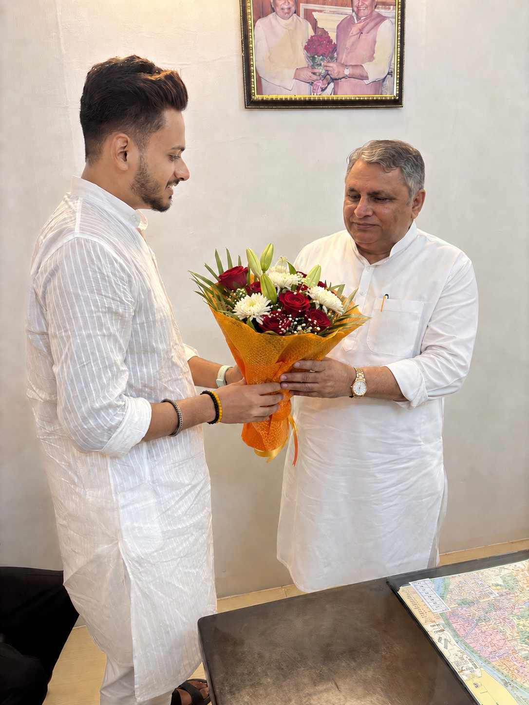 Dibyesh Pandey greeting a senior public figure with flowers